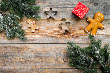 Christmas evening.Gingerbread cookies anf gift near spruce branch on rustic wooden background top view copyspace