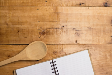 Empty white paper of book and spoon on blank wooden, copy space, kitchen diary concept