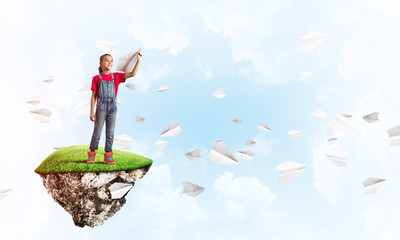 Concept of careless happy childhood with girl playing with airplane