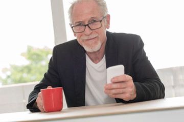 Senior man using his phone