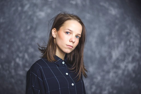 Portrait of a young brunette with sad and serious