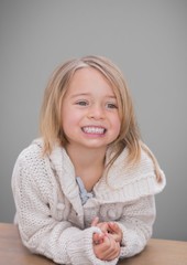 Blonde Girl against grey background with warm jumper