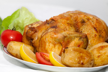 Juicy,crispy roasted chicken for dinner. Chicken with lemon and vegetables.