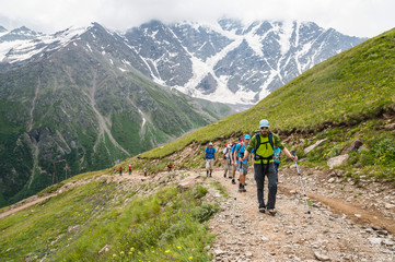 Fototapeta na wymiar Portrait of a group of tourists with backpacks climbing a mountain