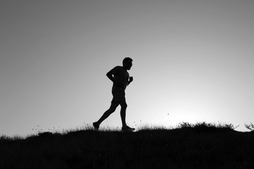 Running man silhouette at sunset