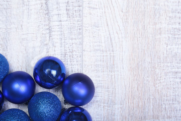 Blue christmas balls on a wooden background