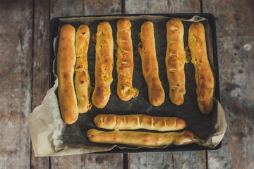 The cooking process: baking with cheese - cheese sticks (long buns)