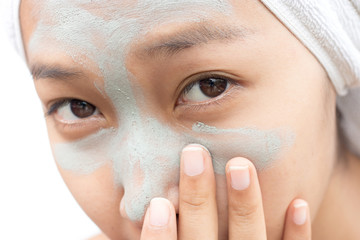 Women are face masks and skin care.