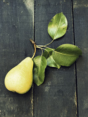 Just picked a pear on a dark wooden surface - vintage look © kidza