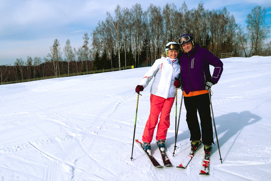 Middle Aged Couple On Ski Holiday In Mountains.