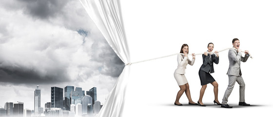 Obraz premium Young businesspeople working in collaboration and pulling white advertisement banner