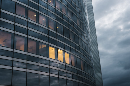 Illuminated office windows in contemporary building at twilight