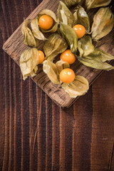 Physalis fruits on wooden board