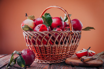Fresh red apples in the basket isolated on brown background