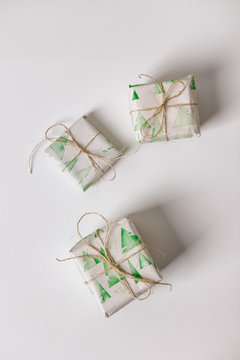 White: Scatterd Christmas Gifts Wrapped In Stamped Paper