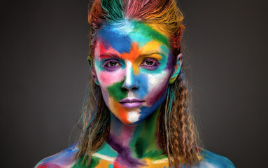 Obraz premium Fashion model girl portrait with colorful paint make up. Sexy woman bright color makeup. Art design. Grey background