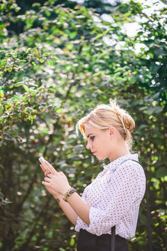 Beautiful blonde woman using her mobile phone