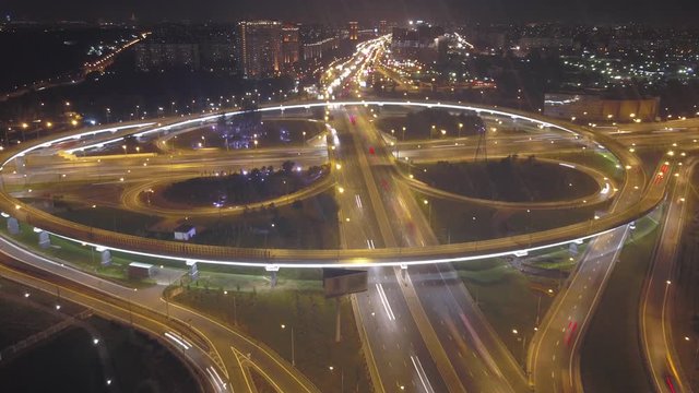Aerial timelapse: Traffic on flyover of Moscow beltway and night cityscape