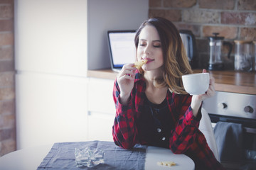Portrait of young woman with cup of tea or coffee