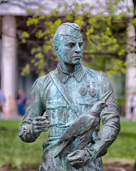 A monument to an unknown soldier. Sculpture. Second World War. A hawk is sitting on a soldier's...