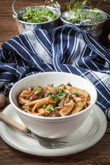 Pasta penne with pork sauce.