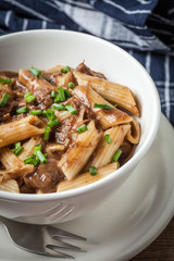 Pasta penne with pork sauce.