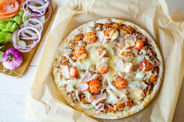 hot fresh homemade traditional italian pizza on wooden table. wallpaper for pizzeria and cooking food concept