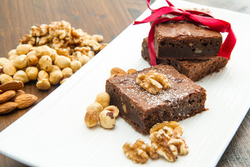 Cake chocolate brownies on white dish with nut