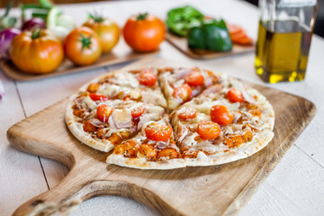 hot fresh homemade traditional italian pizza on wooden table. wallpaper for pizzeria and cooking food concept
