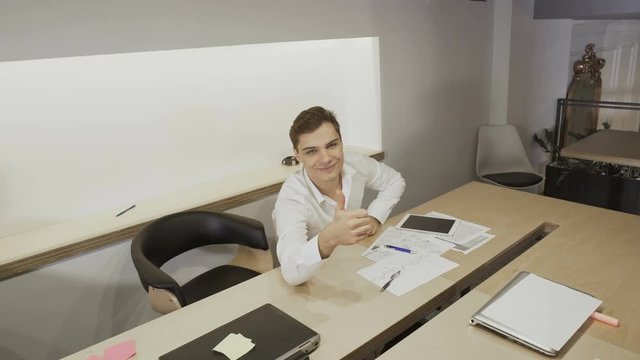 Businessman in suit show thumb-up to camera
