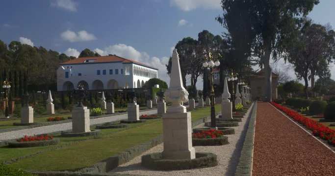 The Mansion of Bahji in Bahai garden decorated with trees, bushes and statue. Acre, Israel