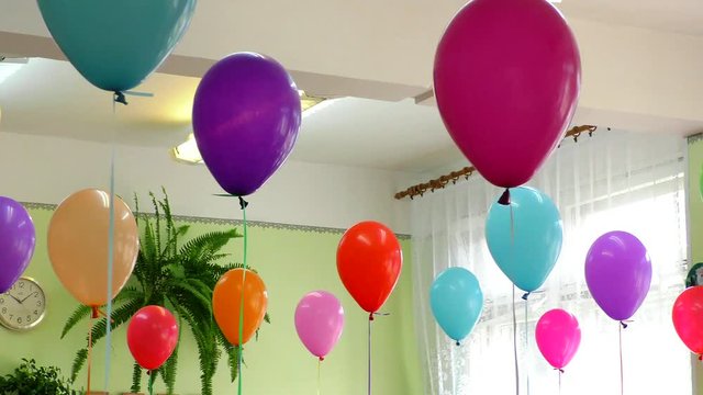 The air of festive colorful balloons in the room. Elegant home decoration for the holiday gel balls.