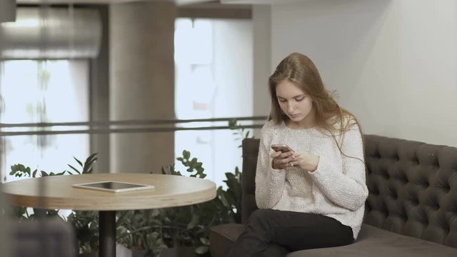 Two girlfriends discuss the pictures in telephone