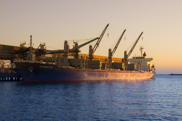 The cargo ship in the port.