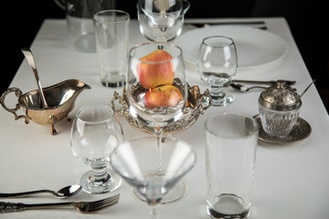 apples on a festive table with glasses and cutlery
