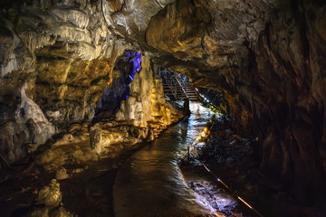 Underground creepy tunnel in dark cave or limestone grotto, speleology nature corridor in Adygeya mountains