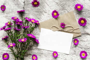 blank white greeting card with pink flowers bouquet and envelope