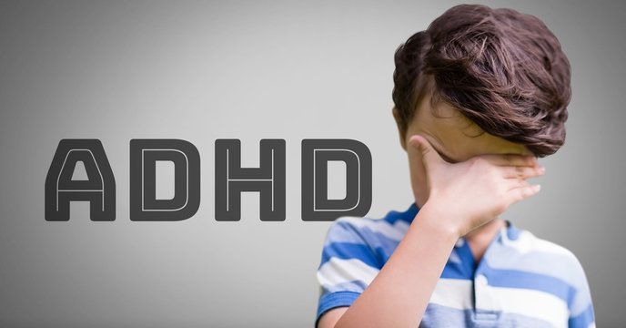 Boy against grey background with ADHD text