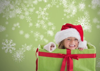 Girl against grey background inside gift box with Santa
