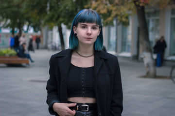 Young, beautiful woman with blue hair is smiling