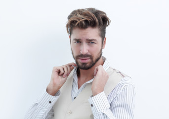 Fototapeta premium A man adjusts the collar of a white shirt