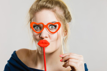 woman holds carnival accessories on stick