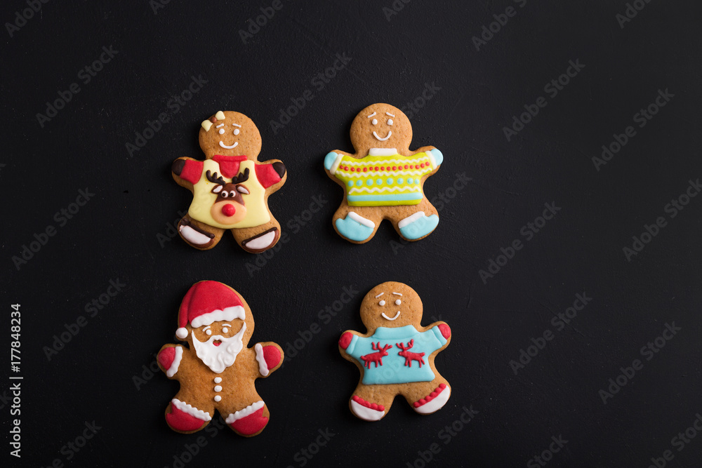 Sticker  Ginger men with colored  glaze on a black background . Gingerbread. Christmas cookies.