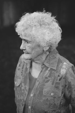 Monochrome portrait of old - elderly - lady staring outside