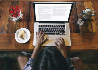Asian Woman Typing on Her Laptop