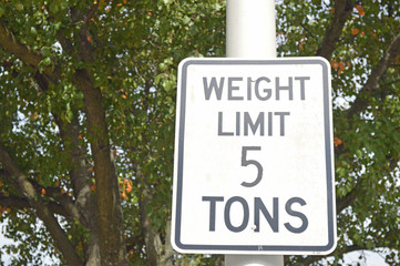 Photo of a rectangular road sign reading weight limit 5 tons