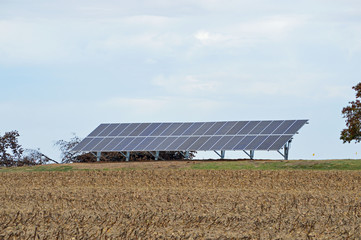 Landscape photo of solar panels in a field on a farm in the country