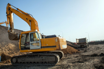 construction machinery at the construction site of the road in the quarry is gaining ground and pouring sand
