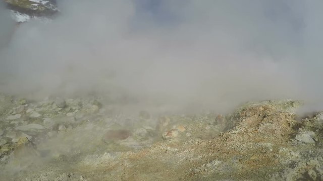 Smoking fumaroles, active sulphur vents of Dachnye Hot Springs - popular tourist attraction in volcanic zone of active Mutnovsky Volcano on Kamchatka Peninsula. Eurasia, Russian Far East.