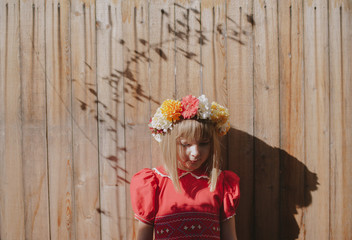Young girl in red dress wearing a homemade floral crown